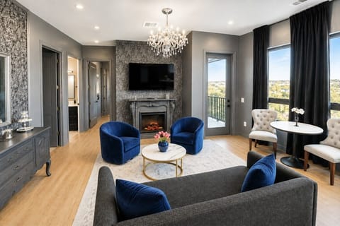 Living room with fireplace, Smart TV, sofa bed, and patio access