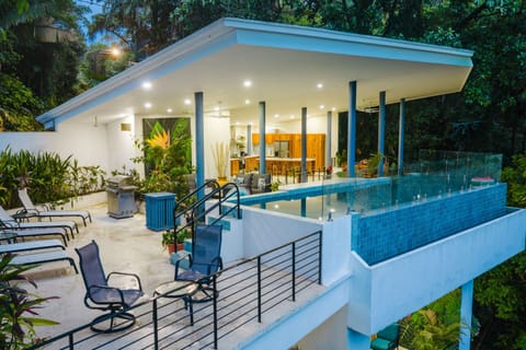 Evenings at Casa Elsa feel magical with glowing poolside views above the jungle