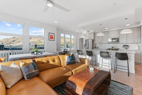 Beautifully designed living room. 75` TV, leather sofa and amazing views of mountains and city skyline.