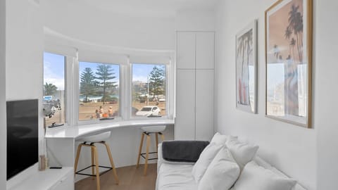 Relax in this bright, airy living space, which offers a cozy sofa and a custom breakfast bar perfectly positioned to take in the coastal views
