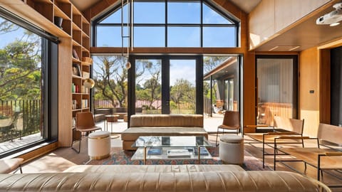 Open lounge area with large windows that blend seamlessly with the surrounding nature.