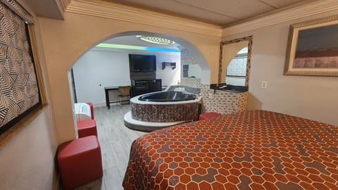 Suite, 1 King Bed, Non Smoking, Jetted Tub | Desk, laptop workspace, blackout drapes, iron/ironing board