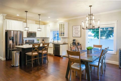 Modern kitchen with stainless appliances + quartz counters.