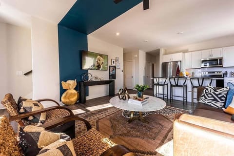 Open concept living area with comfortable seating and TV