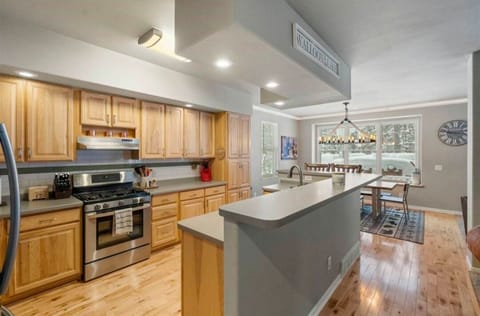 Lower level full kitchen, looking into dining room and out to the expansive deck