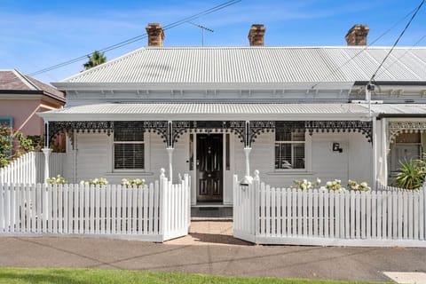 Attractive design of the property with a white fence.