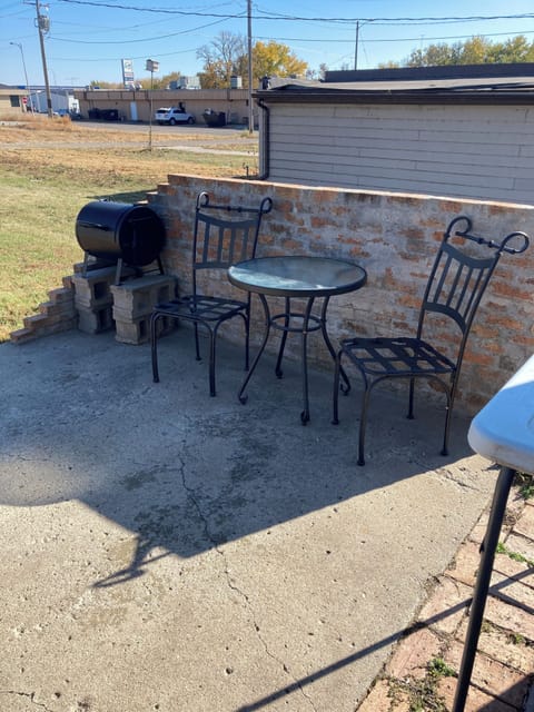 patio with grill, table and chairs