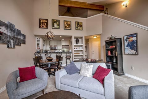 West Elm Loveseat and 2 chairs. High ceilings and rich wood beams bring warmth.