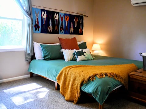 King bed in private, well-lit bedroom