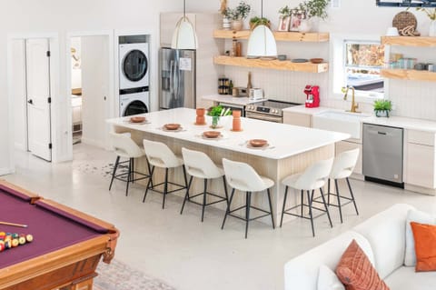 Open-concept space with billiards, full kitchen w bar seating, and unique built-in full bunks.