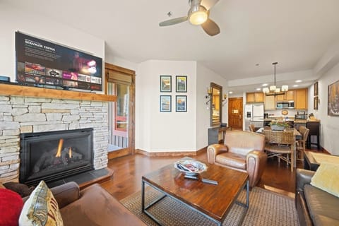 Cozy lounge with fireplace, TV, and seating.