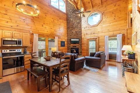 Floor to ceiling stack stone fireplace makes a grand entrance upon arrival.
