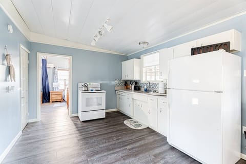 Our simple kitchen has an electric stove and all the cooking things you need. There is also a slow cooker.  The exterior has a BBQ grill on a propane tank.  Not shown is the coffee bar.