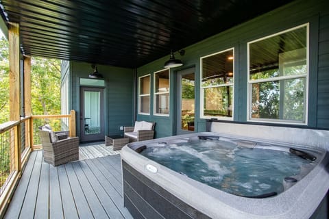 Step into relaxation! Picture this: a hot tub bubbling with warmth and chairs perfectly placed for optimal chill time.