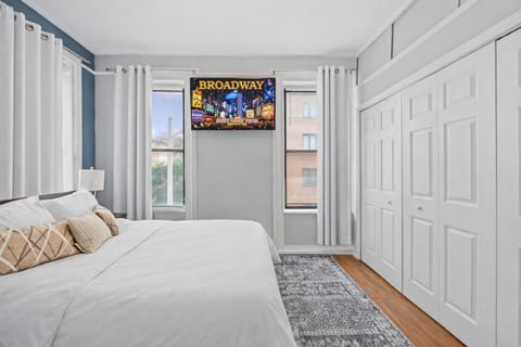 Sunny bedroom with plush bed, ample closets, and chic decor