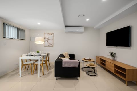 Living Area: Bright living space with comfortable seating and TV 