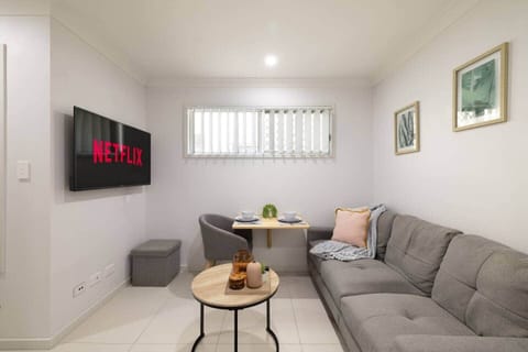 Living Area: Bright living space with comfortable seating and TV 
