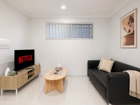 Living Area: Bright living space with comfortable seating and TV 