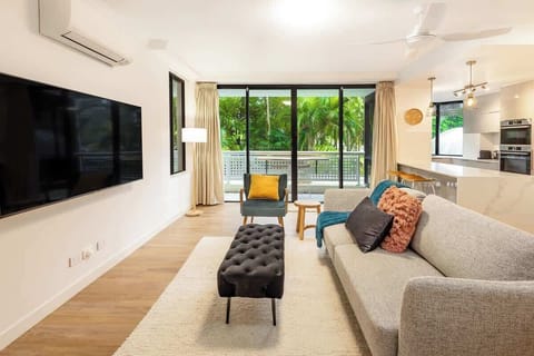 Natural light flows through the open-plan layout, connecting the living, dining, and kitchen spaces to the balcony beyond, making it easy to move between relaxation and entertaining.