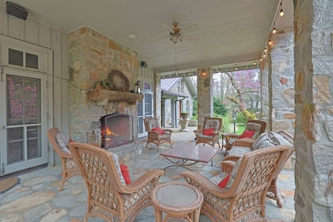 Front covered veranda with wood burning fireplace, lots of seating