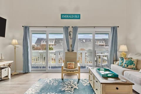 Family room with vaulted ceilings and double sliders to large balcony