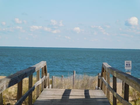 10 Dune Road (39544) - Private Beach Path - A view from the wooden boardwalk leading directly to the sand. Tower Shores residents and guests enjoy private beach access, ensuring a more secluded and relaxing experience just steps from the front door.