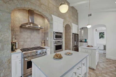 The kitchen features a gas stove and three ovens to make cooking a breeze