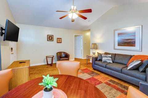 Cozy living space with sofa sleeper, table, and TV