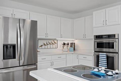 The seamless transition between the living room and kitchen ensures that entertaining becomes effortlessly enjoyable.