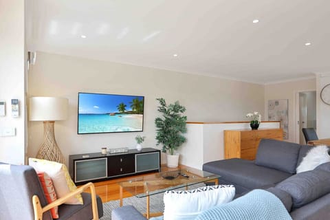 Open living area with large TV and relaxed lounge seating