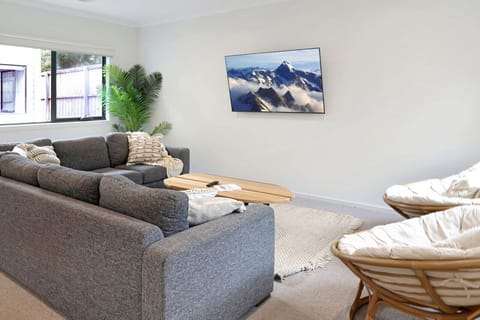 Comfortable living space with TV and natural light