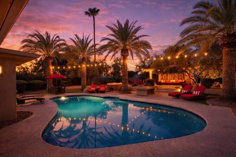 Sparkling pool, hot tub, sun loungers, gazebo, firepit, BBQ, cornhole, and ample seating.