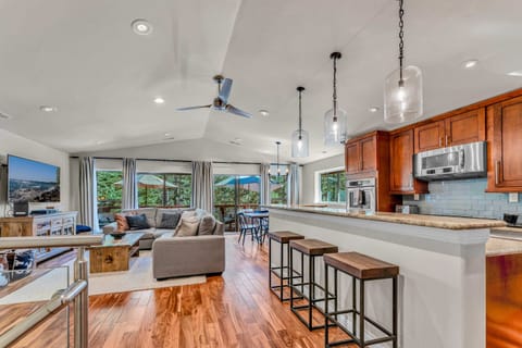 Main Living Space: upper floor, open layout, inviting living room with 65” smart TV, well-equipped kitchen, 6-person dining table, access to deck