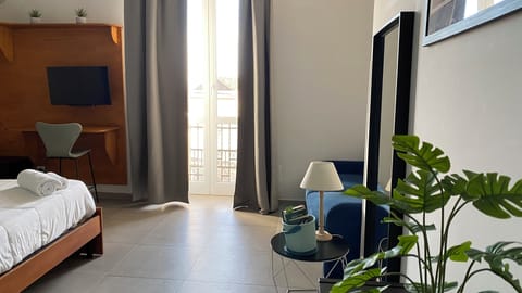 Deluxe Quadruple Room, Balcony, City View | Hypo-allergenic bedding, minibar, desk, laptop workspace