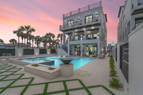 Luxurious 3-story villa with a private pool, hot tub, and spacious balconies. Modern design, perfect for relaxing by the pool or enjoying stunning sunset views. Located steps from the beach!