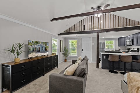 Living room with 50in SMART TV, dresser, Sofa, Kitchen view and second floor view. 2 cealing fans!