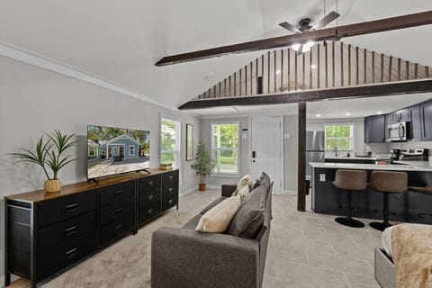 Living room with 50in SMART TV, dresser, Sofa, Kitchen view and second floor view. 2 cealing fans!