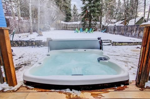 Steaming Hot Tub at 104 attached to New Brazilian Walnut Back Deck. Large Lawn, Horse Shoe Pit and Fire Ring in the Background