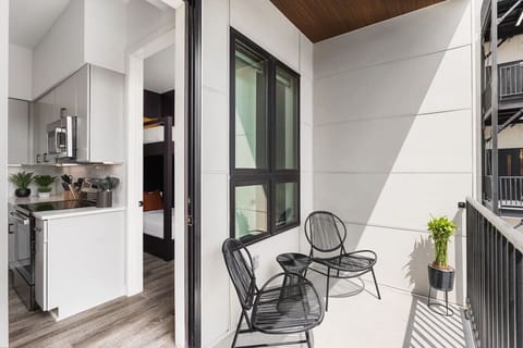 Private balcony with seating for two. This balcony overlooks the building pool for a relaxing morning coffee spot.