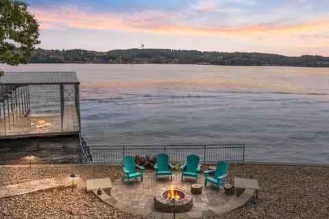 Serene lakeside gatherings with a cozy fire pit and stunning sunset views.
