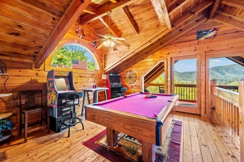 The game room upstairs includes a pool table, multiple arcade games, and beautiful views of the Smoky Mountains.