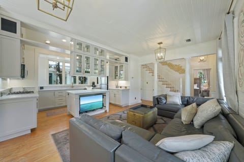 OPEN KITCHEN AND LIVING - SECTIONAL & FLAT SCREEN TV IN CENTER C