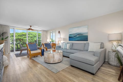 Unwind in your airy living space where soft coastal colors, lush treetop views, and gentle breezes create the perfect retreat after sun-soaked island adventures.