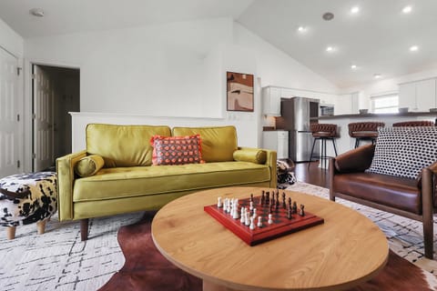 Plush seats in the living room with a chess game on the center table