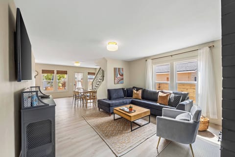 Enter into the living room and dining room with a smart TV and new furniture.