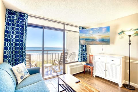 This beautiful oceanfront living room is perfect for relaxing on a sunny vacation day.   Sit on the plush full-sized couch and stream your favorite apps or channels on the 50` Smart TV.  Walk out on the oceanfront balcony.