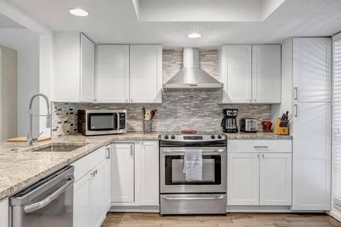 - Cook in style in this sleek kitchen with stainless steel appliances, granite counters, & a custom tile backsplash
- Equipped with microwave, coffee maker, and all the essentials
- Perfect setup for breakfast prep or dinner with the group