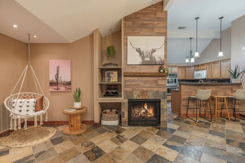 Cozy firepit inside the wall, antique CD player, and swing for relaxation
