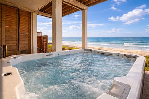 Beach Girl's private hot tub offers a relaxing beachfront experience with beautiful views of the ocean.