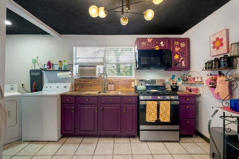Fully stocked kitchen with gas stove, overhead microwave and all utensils needed for meal prep
